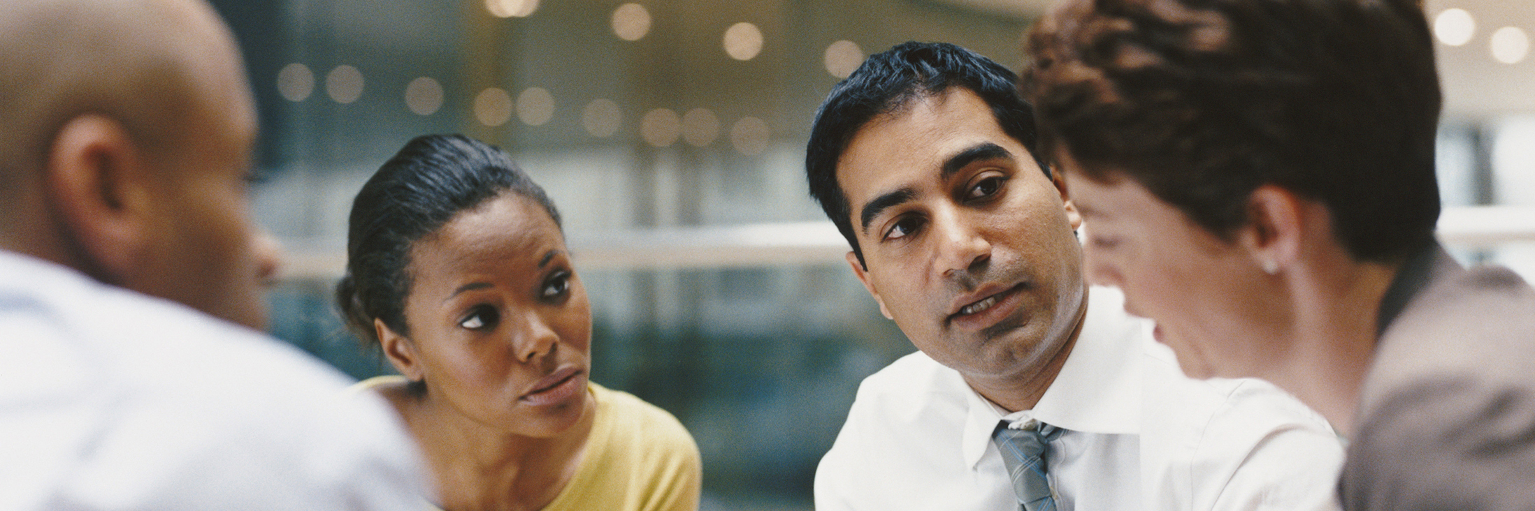 Business People Sitting in an Office Building Having a Meeting