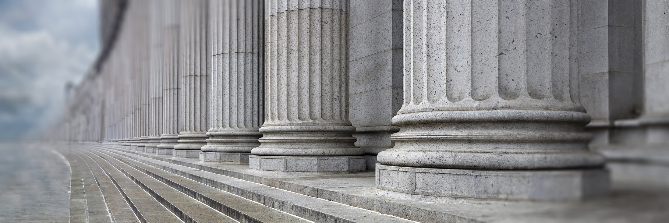 Stone colonnade and stairs detail. Classical pillars row in a building facade